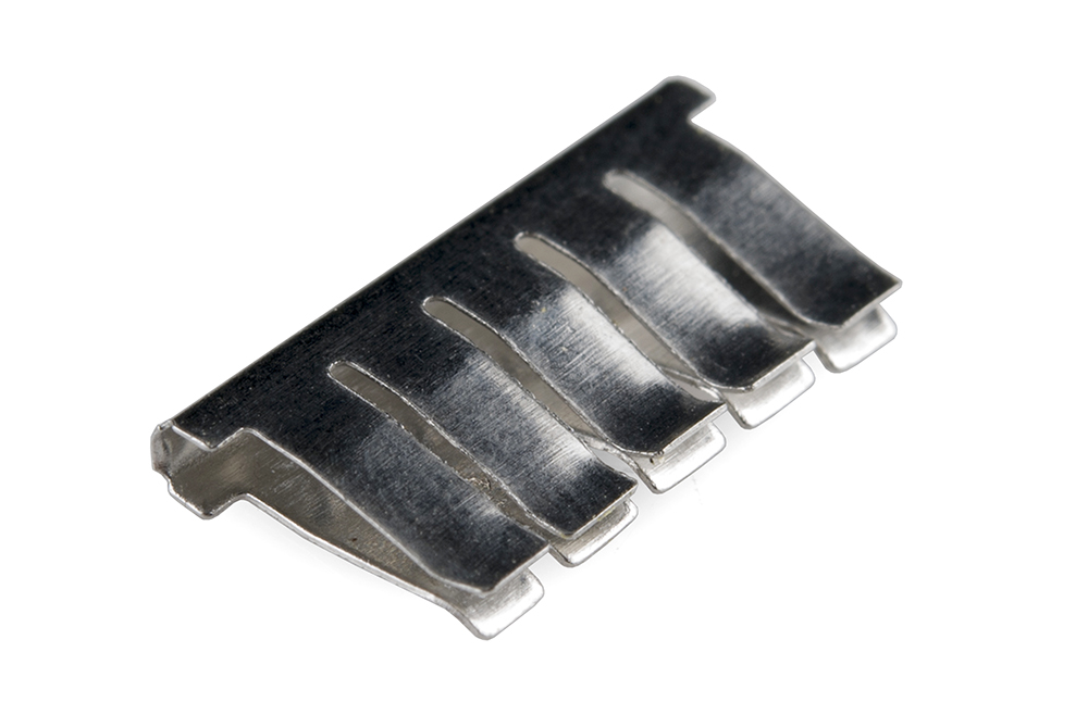 Close-up of a breadboard row showing metallic grabber contacts that grip inserted wires.