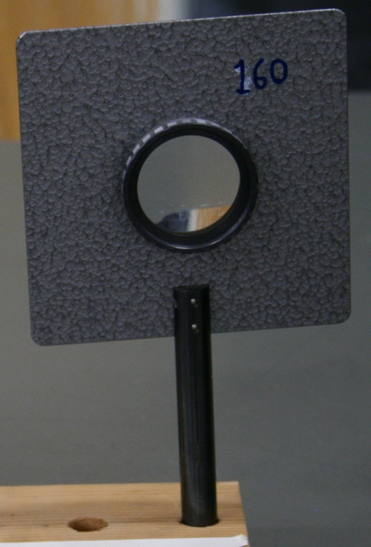 A golf-ball-sized 160 mm lens within a square barrier mounted on a stem.