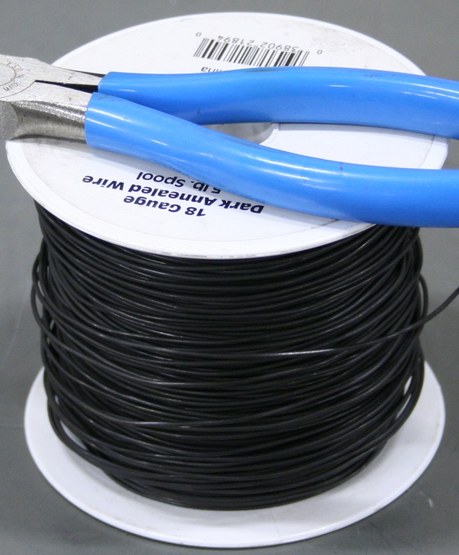 Spool of 18 gauge dark annealed iron wire.