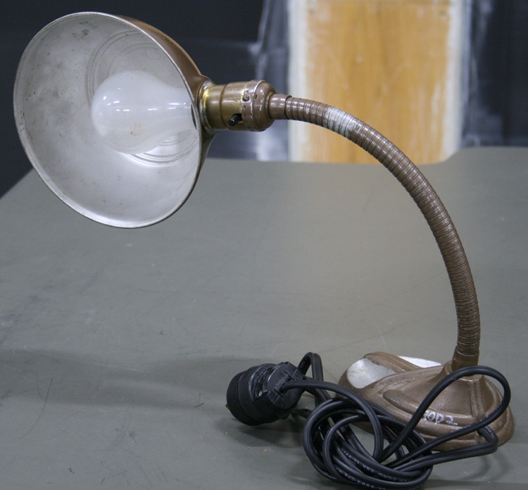 Gooseneck desk lamp with adjustable hemispherical hood.
