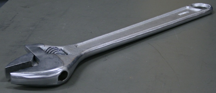 A comically large adjustable crescent wrench.