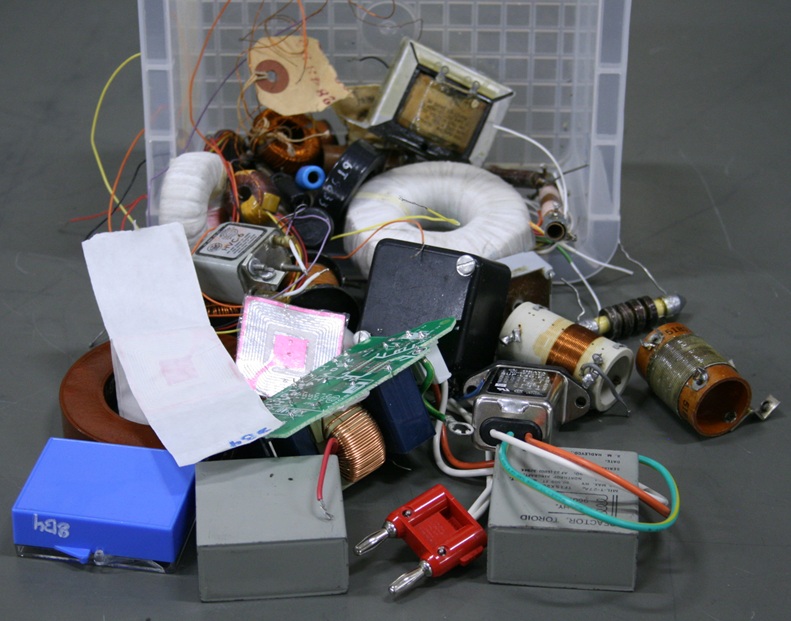 A haphazard pile of diverse inductors palm-sized or smaller.
