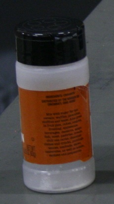 A plastic spice shaker with a flip-top cap.