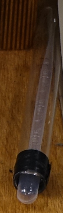 A 3 milliliter plastc pipette is stored in the cartesian diver test tube.