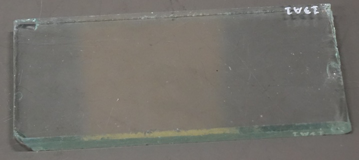 A clear glass plate 7 by 4 by 3/8 inch.