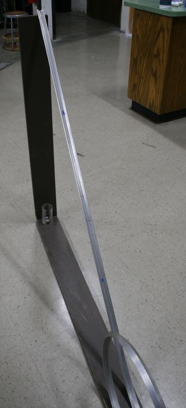 Close-up of the lower track section showing the metal channel, support frame, and blue reference marks on the track