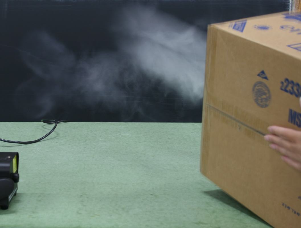 Fog being expelled from the cardboard box after striking the back panel