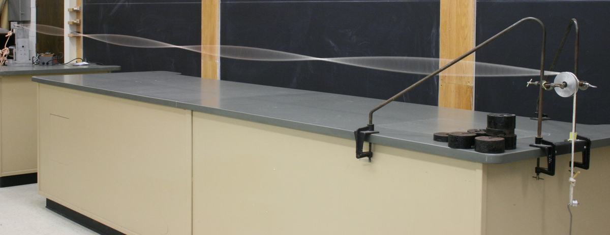 Rope displaying a standing wave pattern with yet another harmonic mode, showing more antinodes than the previous images