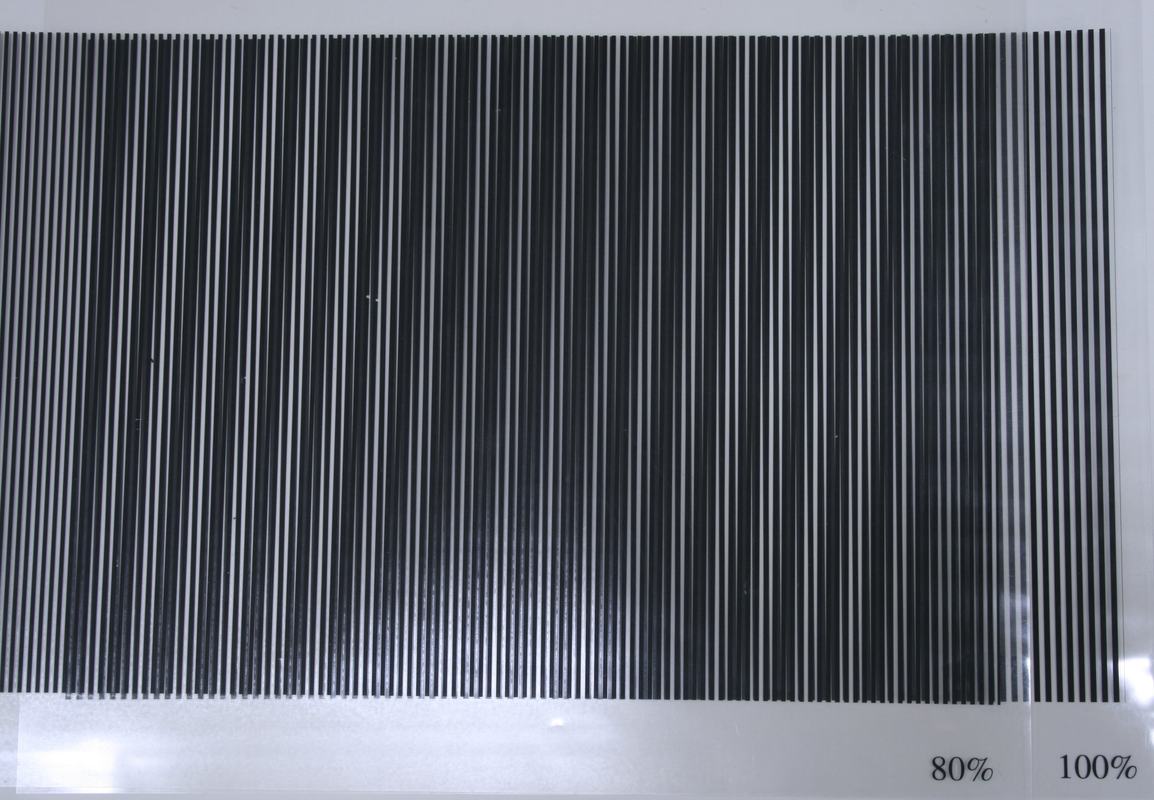 Two overlapping transparency sheets at 80% and 100% line density, showing more pronounced beat pattern with wider dark and light bands