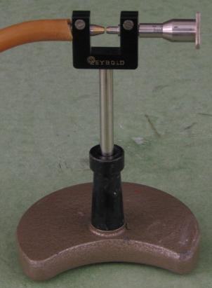 Galton's whistle mounted on a Leybold stand with rubber hose for compressed air supply