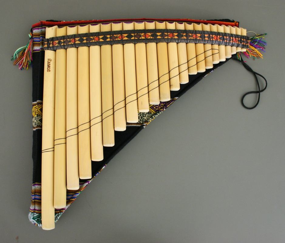 Professional panpipes made of giant cane with graduated tube lengths, bound by colorful Andean woven textile straps