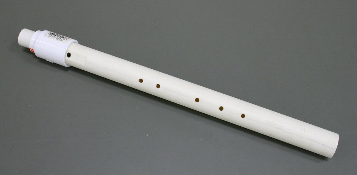 White PVC flute with wider diameter body and smaller tone holes, mouthpiece fitting at one end