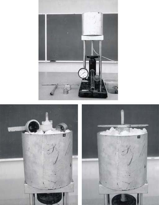 Three views of the ice fountain apparatus: top shows the hydraulic jack with pressure gauge, central cylinder, and conical nozzle on a demo bench with tools; bottom-left shows the outer cylinder filled with crushed ice and the nozzle visible at top; bottom-right shows an extruded ice cylinder emerging from the nozzle