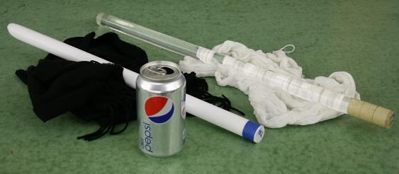 Charging rods (white Teflon rod and clear glass rod) with fur and silk charging materials, alongside a Pepsi aluminum can