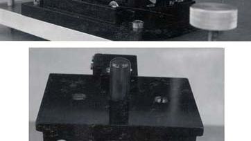 Two views of a compact black metal Millikan Oil Drop Chamber with viewing ports, adjustment knobs, and a label reading "MILLIKAN OIL DROP CHAMBER D = 0.237 ± 0.002 IN"
