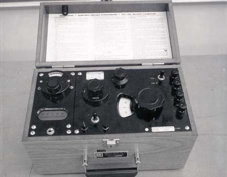 Honeywell portable potentiometer in a wooden case, showing rotary dials, decade selector knobs, and a center-zero galvanometer on the front panel