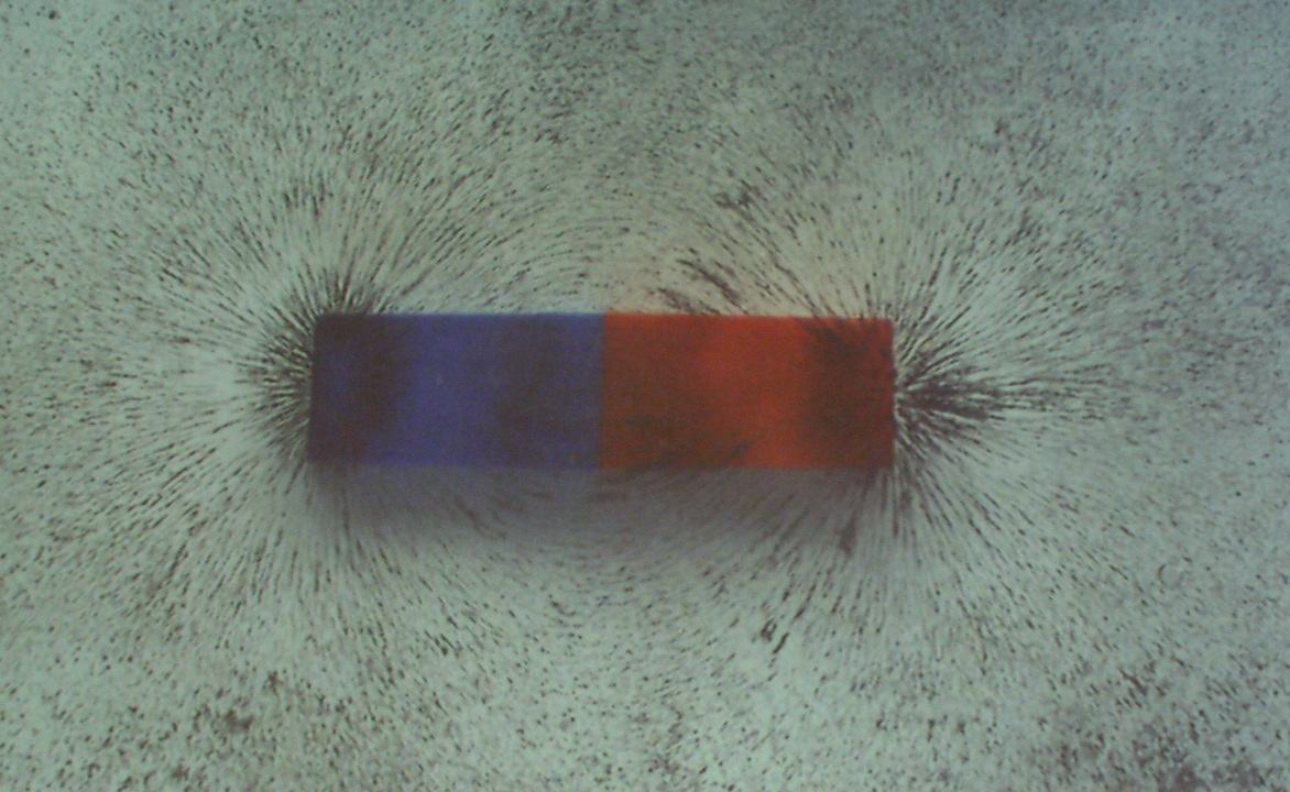 Projected view of a single bar magnet (blue and red halves) with iron filings showing the classic dipole field pattern