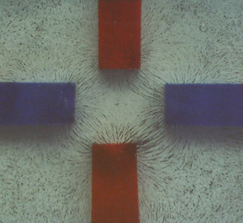 Two bar magnets at angles showing asymmetric iron filing field patterns