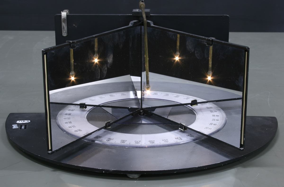Hinged mirrors set at a wider angle (approximately 90 degrees) on the protractor base, showing fewer reflected images of the light bulb