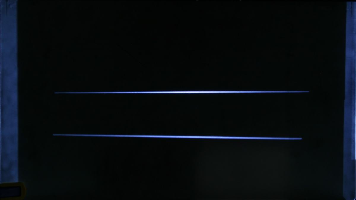Two thin horizontal blue-white lines on a dark screen, projected through the slit mask from dual flashlights