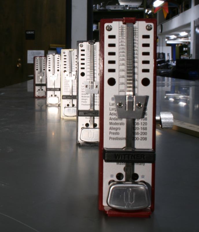 Same row of Wittner metronomes from the same angle, now with nearly all metronomes in sharp focus from foreground to background