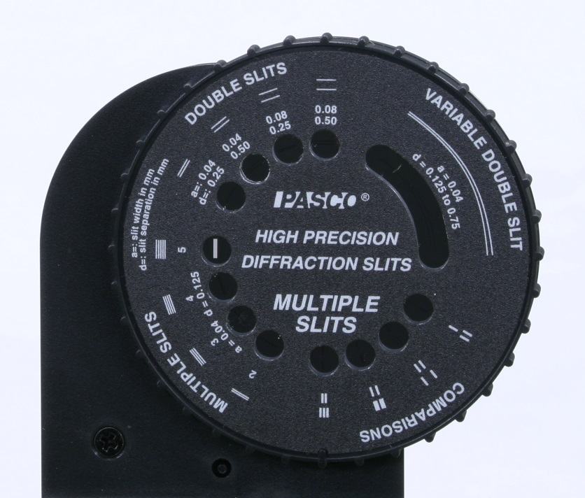 Close-up of PASCO High Precision Diffraction Slits wheel showing sections for Double Slits, Variable Double Slit (d = 0.125 to 0.75 mm), Multiple Slits, and Comparisons