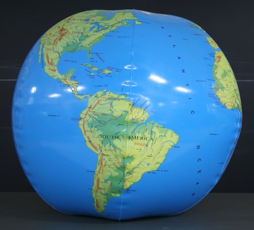 Large inflatable physical globe showing South America, Caribbean, and Atlantic with topographic relief
