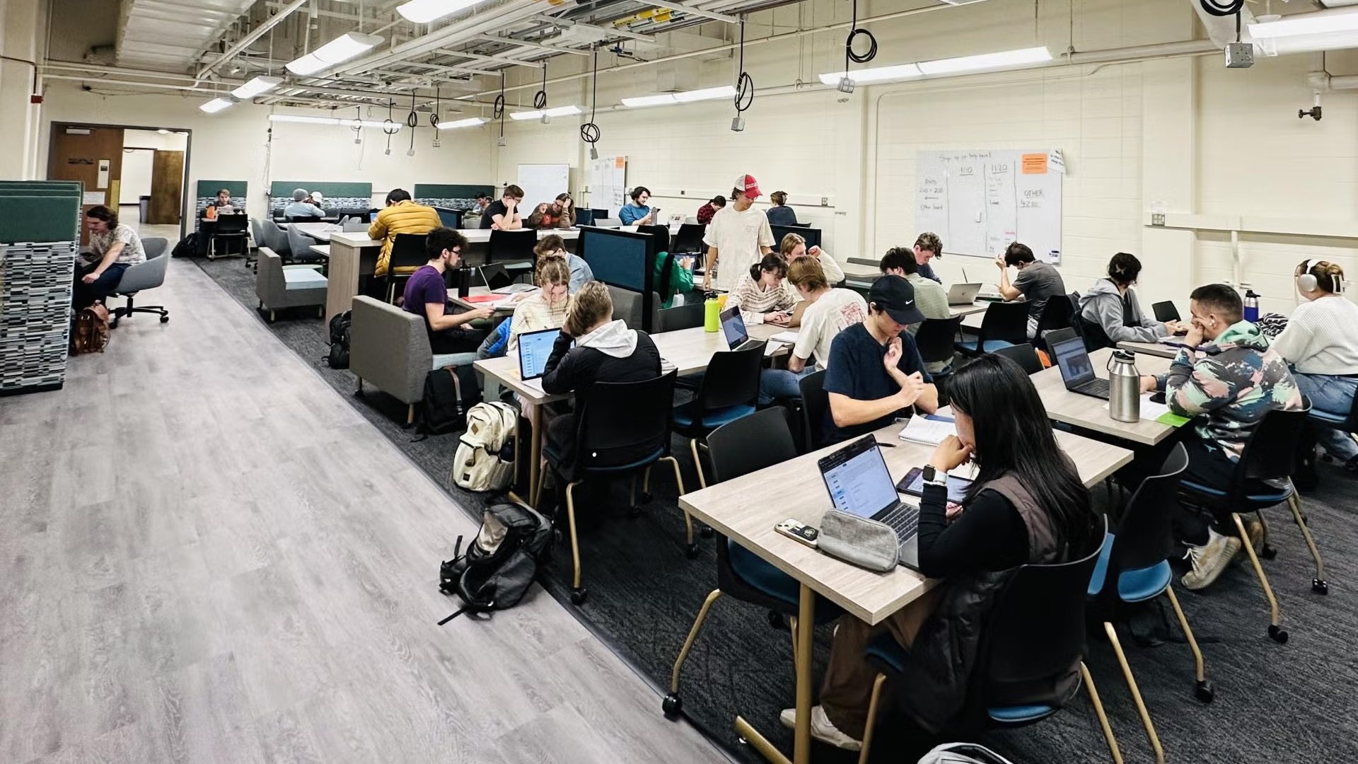 Students working at tables in the CU Boulder Physics Help Room